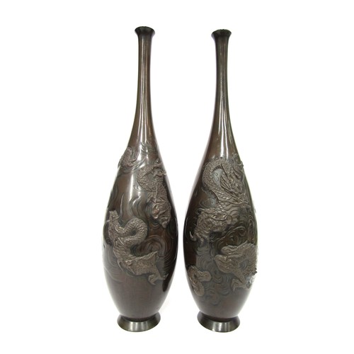 9046 - A pair of Japanese bronze vases with applied stylised dragons, 37cm tall