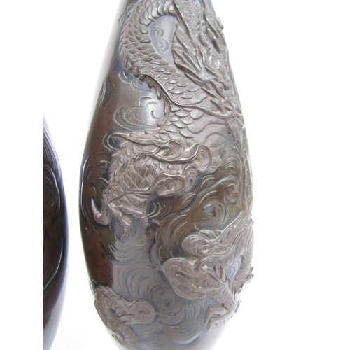 9046 - A pair of Japanese bronze vases with applied stylised dragons, 37cm tall