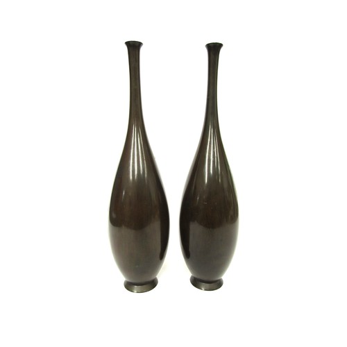 9046 - A pair of Japanese bronze vases with applied stylised dragons, 37cm tall