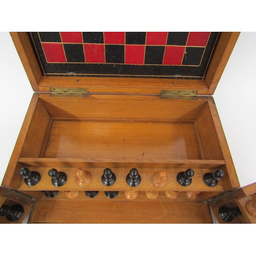 9056 - An early 20th Century oak cased games compendium with boxwood and ebony chess pieces (king 2.5” high... 