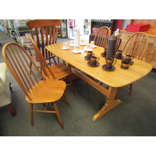 1015 - An Ercol dining table, 71cm high x 150cm long x 76cm wide, together with four associated chairs