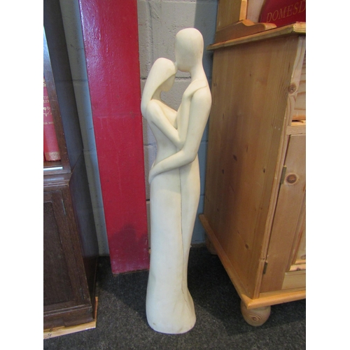 1038 - A stone floor-standing figure of couple embracing, 81cm high