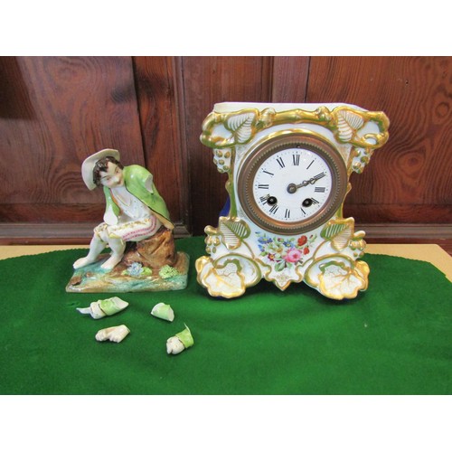 1259 - A Continental style clock garniture with gilt and flower design, mounted by a seated gentleman (a/f)... 