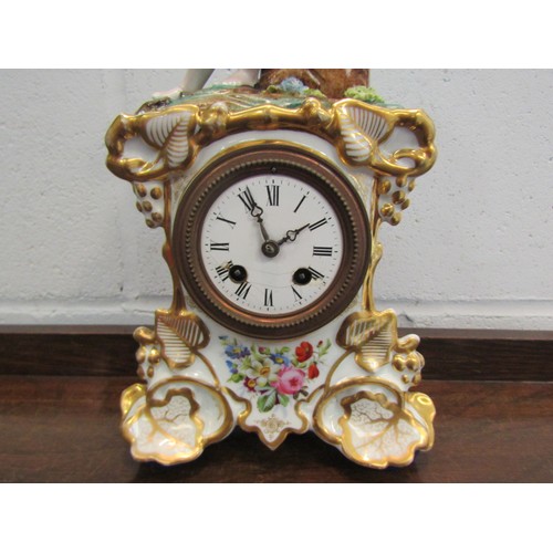 1259 - A Continental style clock garniture with gilt and flower design, mounted by a seated gentleman (a/f)... 