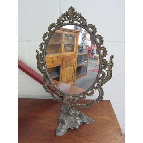 1003 - An ornate metal dressing table mirror, 52cm high