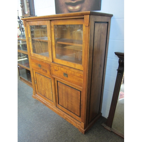 1010 - A 20th Century satin walnut Biedermeier style glazed cabinet with sliding top doors over a two drawe... 