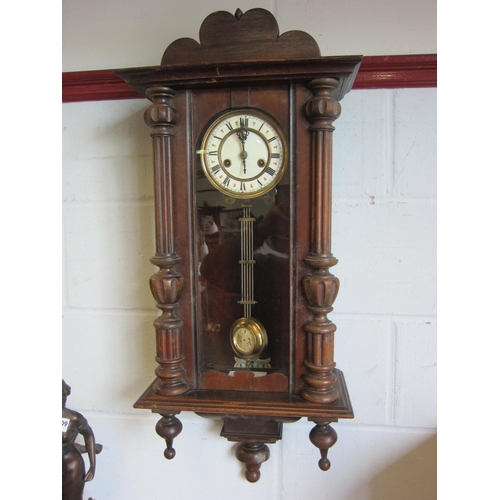 1011 - A mahogany wall clock with ceramic dial and fluted column supports
