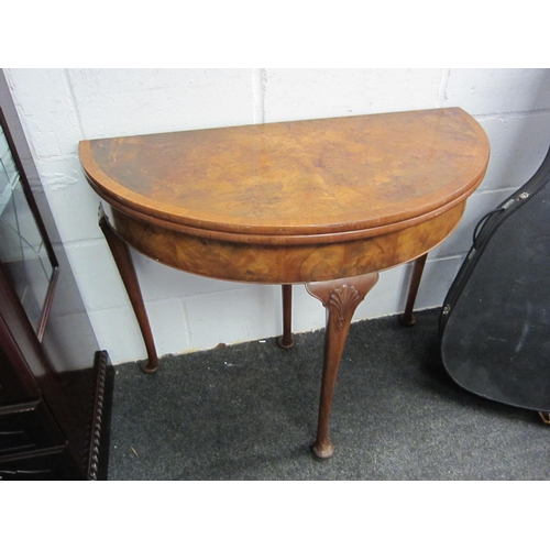 1028 - An early 20th Century mahogany demi-lune walnut card table with baize surface to interior     (R) £6... 