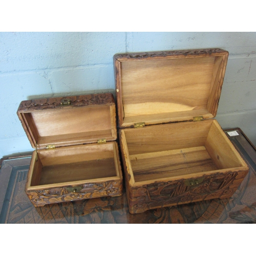 1074 - Two 20th Century camphor wood graduated carved boxes/chests with Oriental landscape scenes, 19cm hig... 