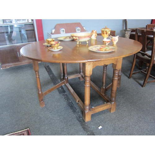 1081 - An oak gate-leg dining table, 143cm x 126cm     (R) £50