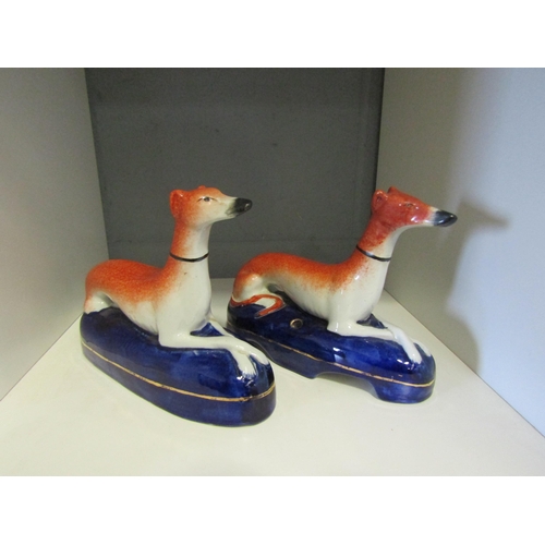 1246 - A pair of Staffordshire seated hunting hounds, 14cm height