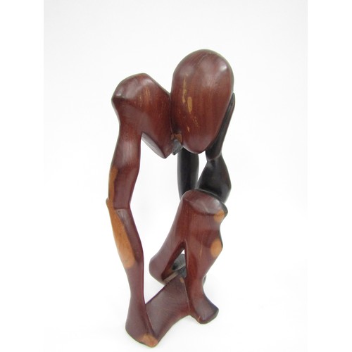 9030 - A modernist carved hardwood sculpture of a man with head in hands (split), 45cm tall