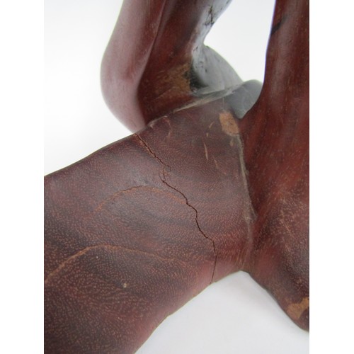 9030 - A modernist carved hardwood sculpture of a man with head in hands (split), 45cm tall