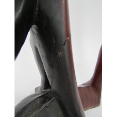 9030 - A modernist carved hardwood sculpture of a man with head in hands (split), 45cm tall