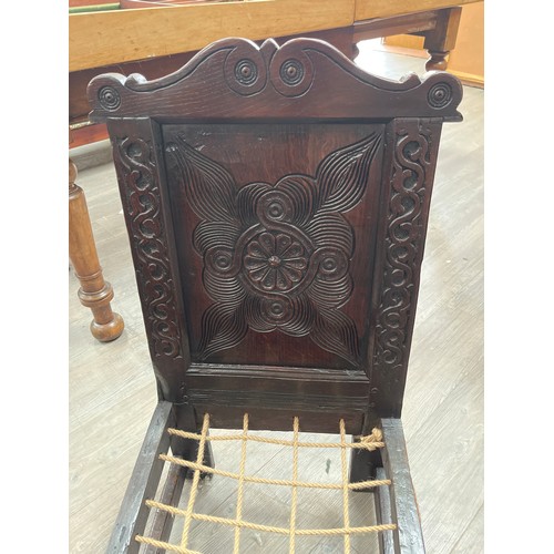 9043 - A 17th Century oak nursing/lambing chair with rope seat supports and later seat cushions  (R)  £150