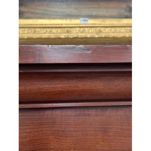 9052 - A Victorian mahogany wardrobe, twin doors opening to reveal hanging and drawer space