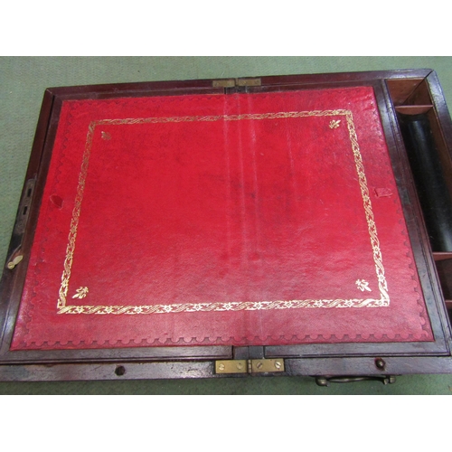 4012 - A mahogany writing slope with red tooled leather interior and secret drawers