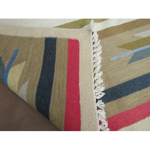 4015 - A geometric pattern rug, beige ground, tasselled ends, 176cm x 121cm