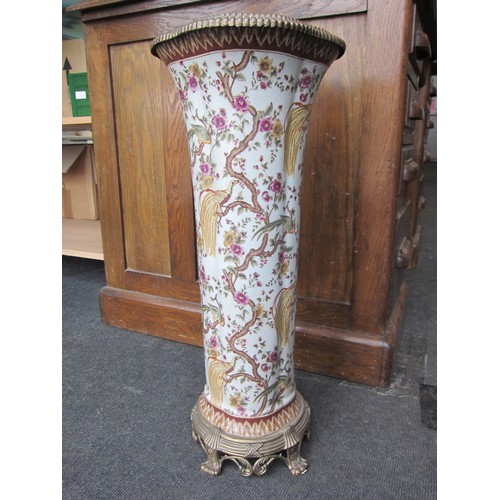 1069 - A late 20th Century ceramic stick stand having gilt brass mounts decorated with birds of paradise in... 