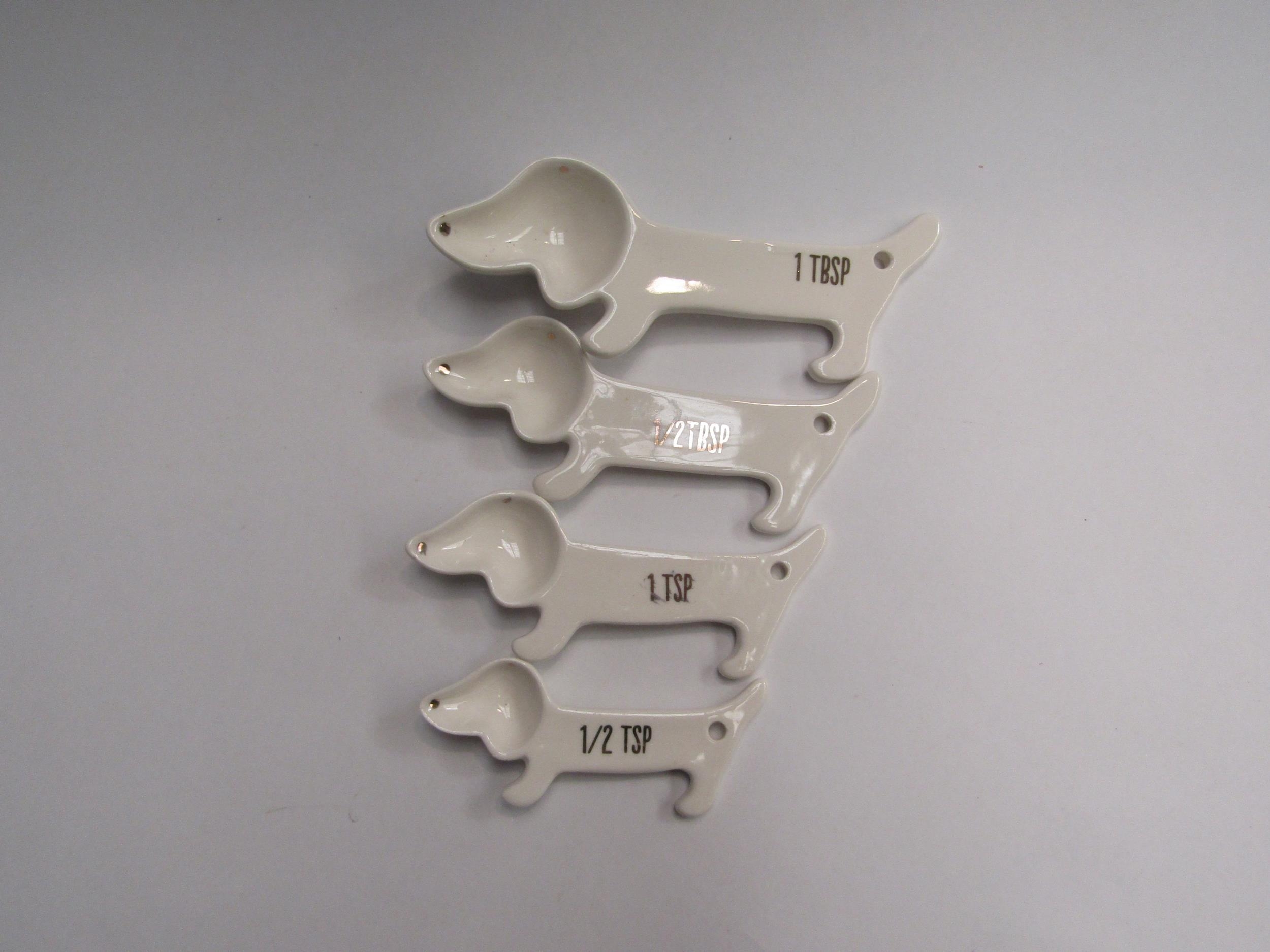 A set of four ceramic Dachshund measuring spoons