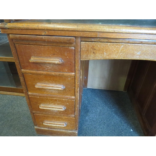 1040 - An early 20th Century oak rolltop desk with green leather insert (worn), eight drawers and two brush... 