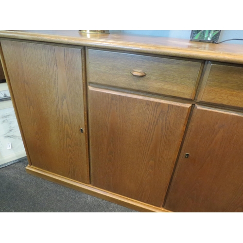 1065 - A modern oak sideboard, two short drawers over two cupboard doors flanked by doors, 82cm high x 170c... 