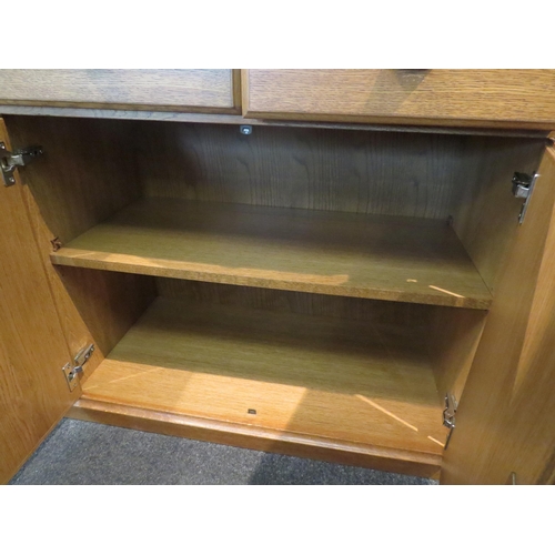 1065 - A modern oak sideboard, two short drawers over two cupboard doors flanked by doors, 82cm high x 170c... 