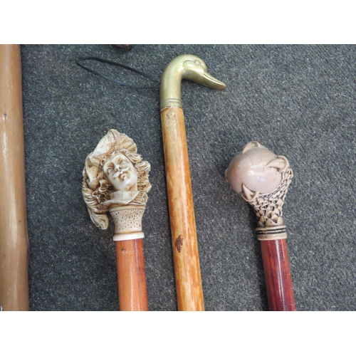 1069 - Four walking sticks including example with figural knop and another with claw grasping an egg (4)