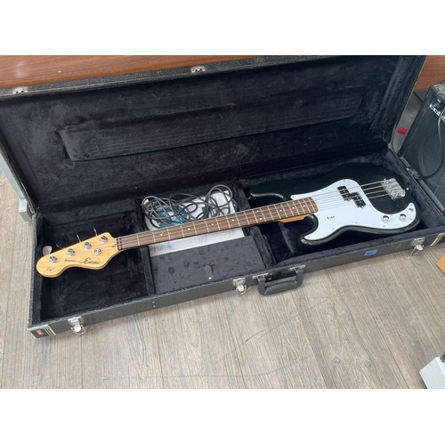 8169 - An Encore Jazz Bass, black body, with flight case, together with a practice amplifier