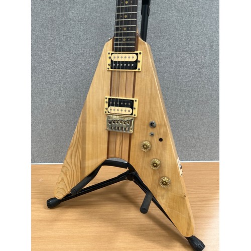 8179 - A 1970s Flying V electric guitar with segmented hardwood and ash body, thought to be by Kay, hard fl... 