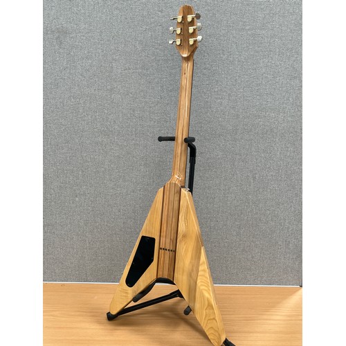 8179 - A 1970s Flying V electric guitar with segmented hardwood and ash body, thought to be by Kay, hard fl... 