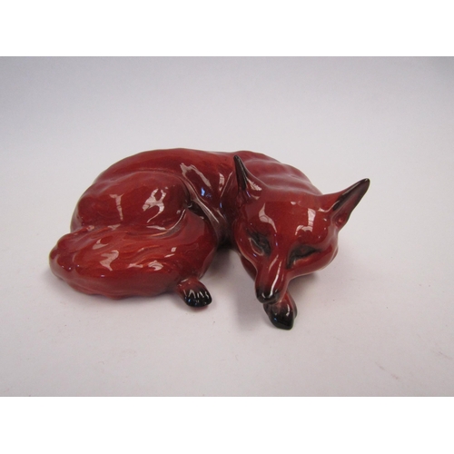 9061 - A Beswick Fox, curled, in gloss, model no. 1017