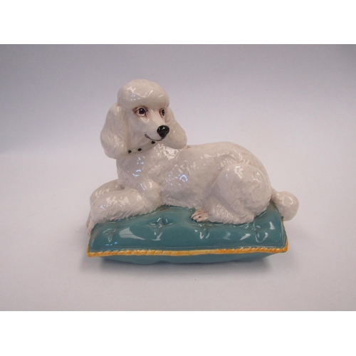 9067 - A Beswick figure of a poodle seated on a cushion, model no. 2985