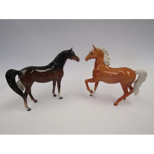 9084 - A Beswick Palomino (Prancing Arab Type) in gloss, model no. 1261 together with a Beswick Arab 