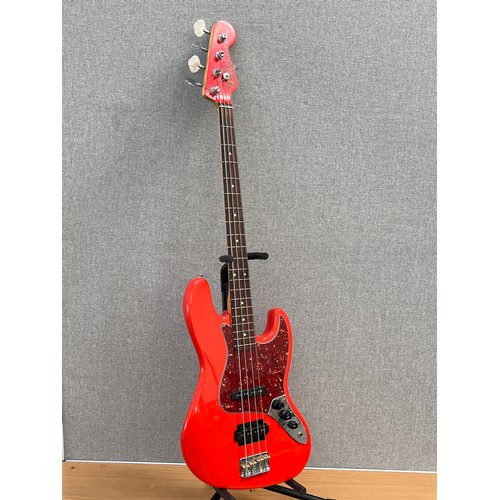 8189 - A Fender Jazz bass, red body with tortoiseshell effect pickguard, the body neck pocket dated 2000, s... 