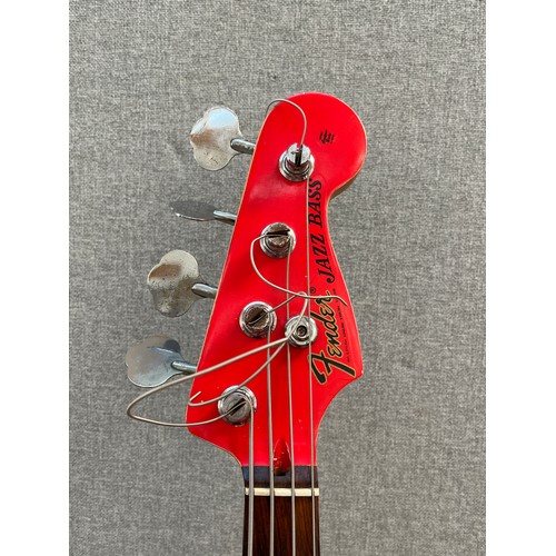 8189 - A Fender Jazz bass, red body with tortoiseshell effect pickguard, the body neck pocket dated 2000, s... 