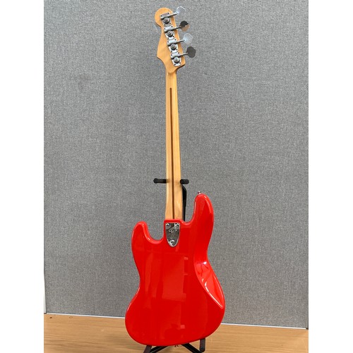 8189 - A Fender Jazz bass, red body with tortoiseshell effect pickguard, the body neck pocket dated 2000, s... 