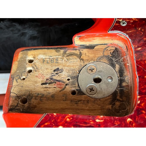 8189 - A Fender Jazz bass, red body with tortoiseshell effect pickguard, the body neck pocket dated 2000, s... 