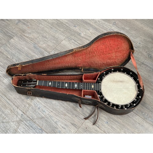 8193 - An early 20th Century five string banjo, short scale, closed back, with original case (a/f)