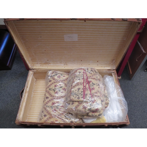 1102 - A vintage trunk containing assorted linens and curtains