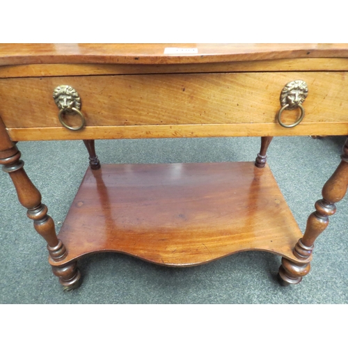 1104 - An occasional table on castors, lion mask handles and under-tier   (E) £15-25