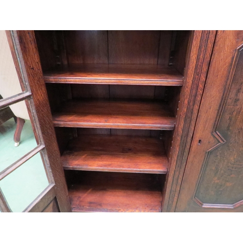 4057 - In the manner of Titchmarsh & Goodwin a carved oak three door bookcase (two panel glazed) with two k... 