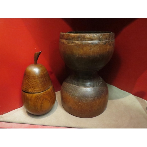 4066 - A large treen vessel, 26cm high, wooden lidded pear and a book press screw (3)