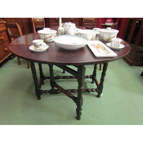 4085 - An 18th Century pegged oak country cottage oval top gateleg dining table the rising leaves over turn... 