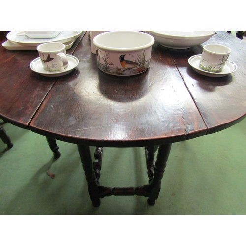 4085 - An 18th Century pegged oak country cottage oval top gateleg dining table the rising leaves over turn... 