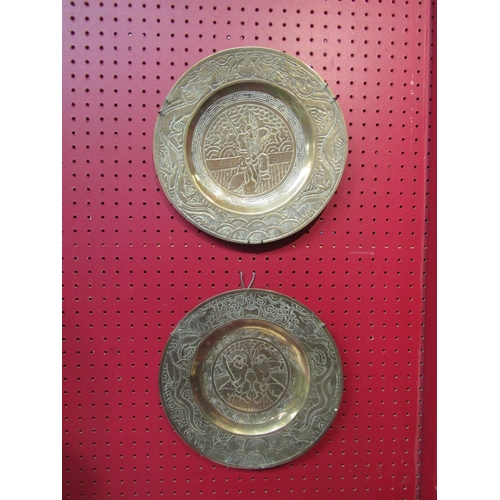 4096 - A pair of Japanese brass chargers with character marks to base, 26cm diameter