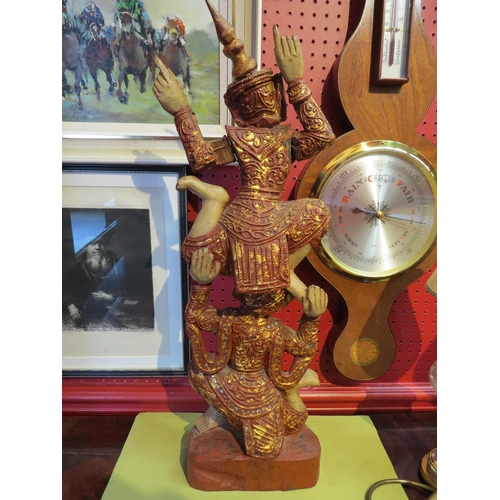 4102 - An Indonesian carved wooden figure embellished with gold and silver, a/f, 61cm high