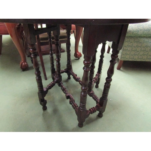 4105 - An 18th Century country oak gate leg table of small proportions the oval top rising leaves on turned... 