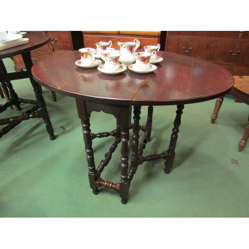 4105 - An 18th Century country oak gate leg table of small proportions the oval top rising leaves on turned... 