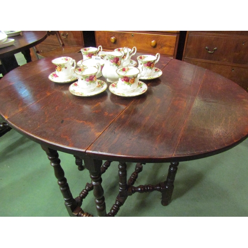 4105 - An 18th Century country oak gate leg table of small proportions the oval top rising leaves on turned... 